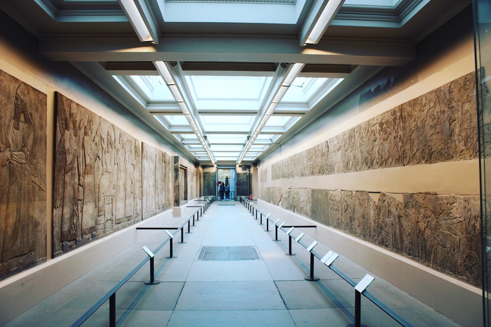 a walkway with benches and a ceiling