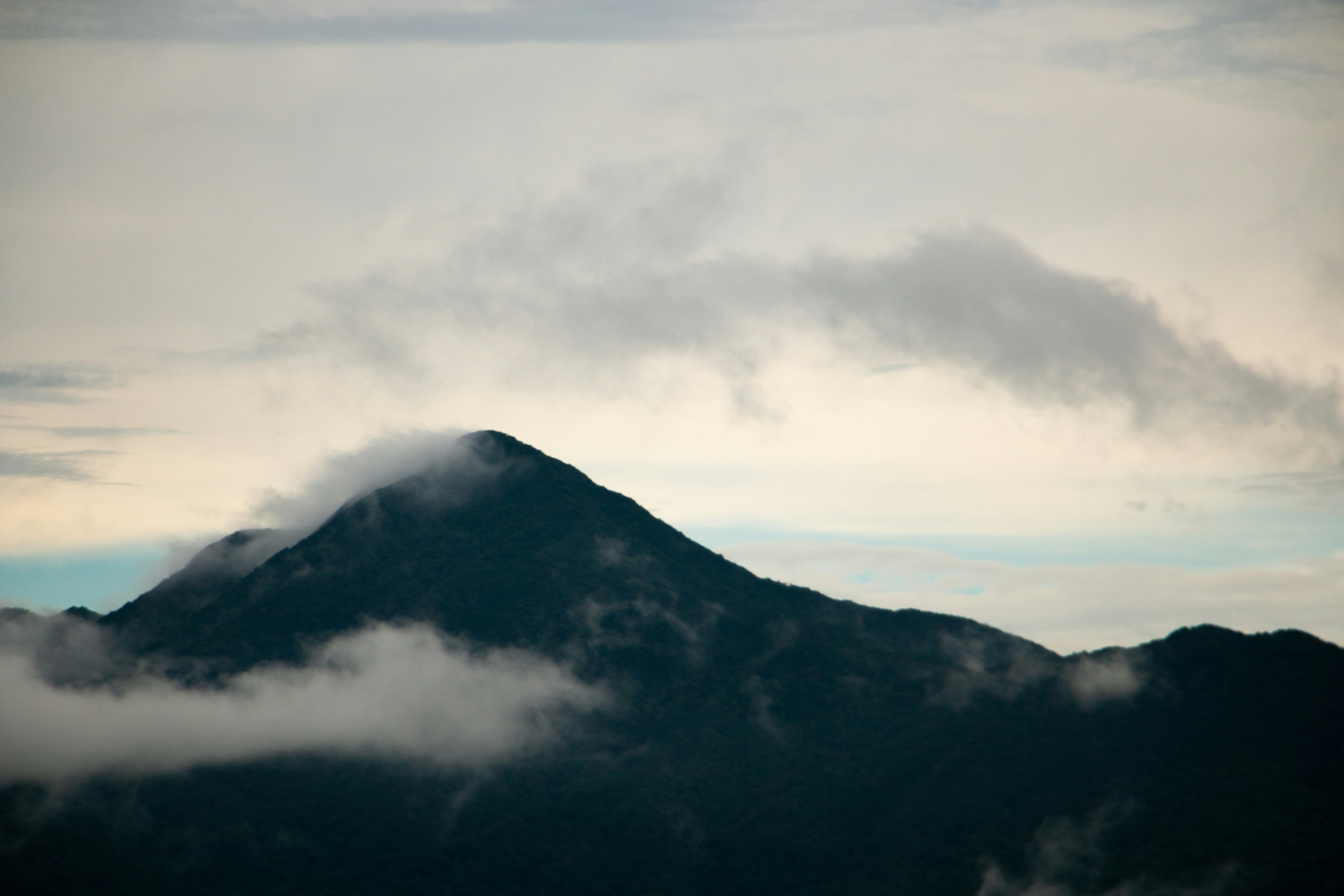 a mountain with clouds around it