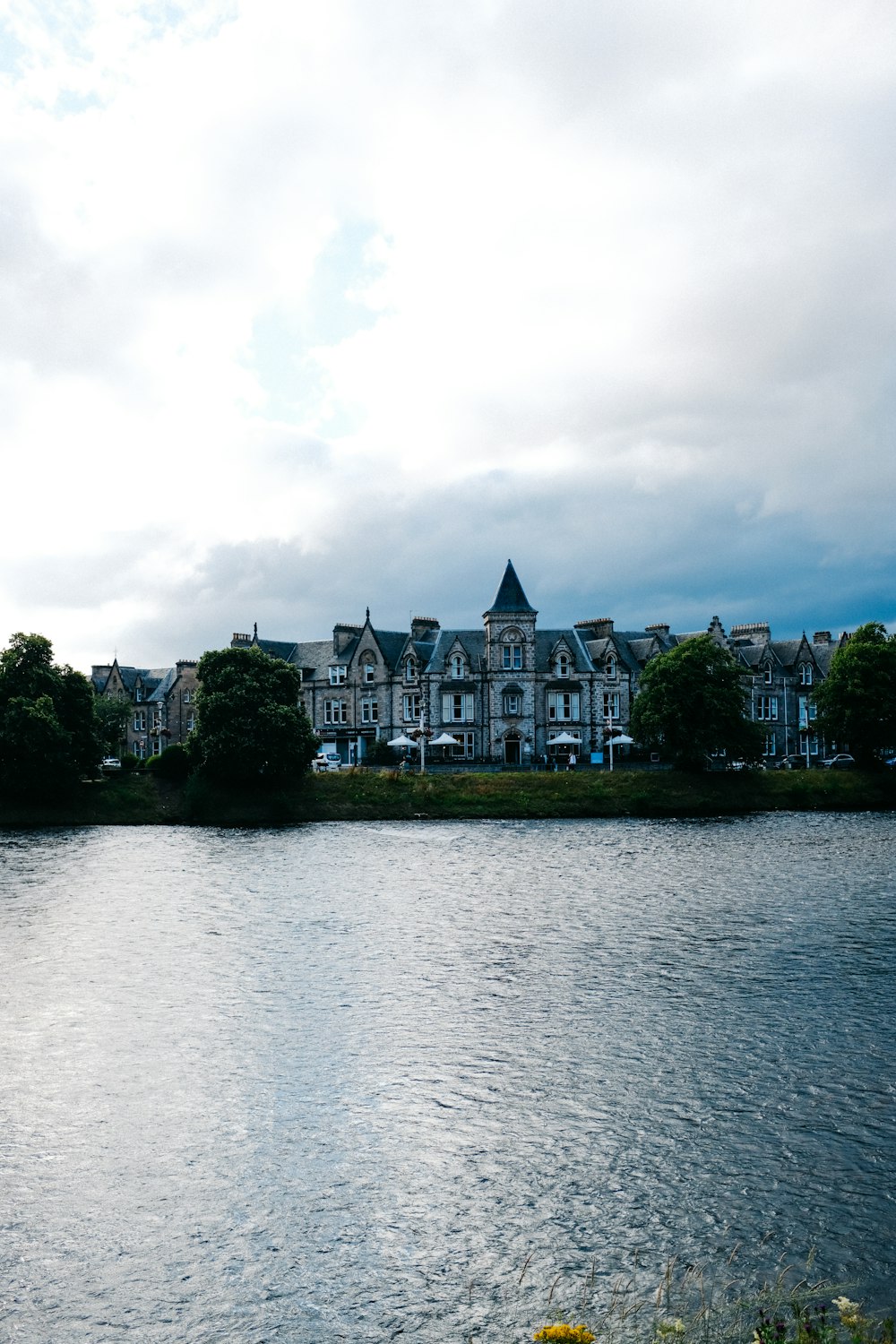 a large building with a tower by a body of water