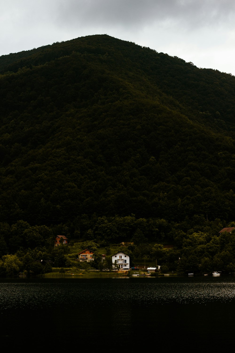 a house on a hill by a lake