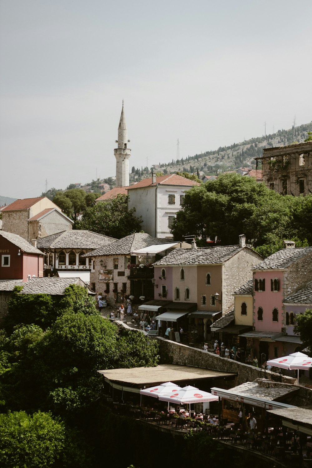 a group of buildings with a tower in the background