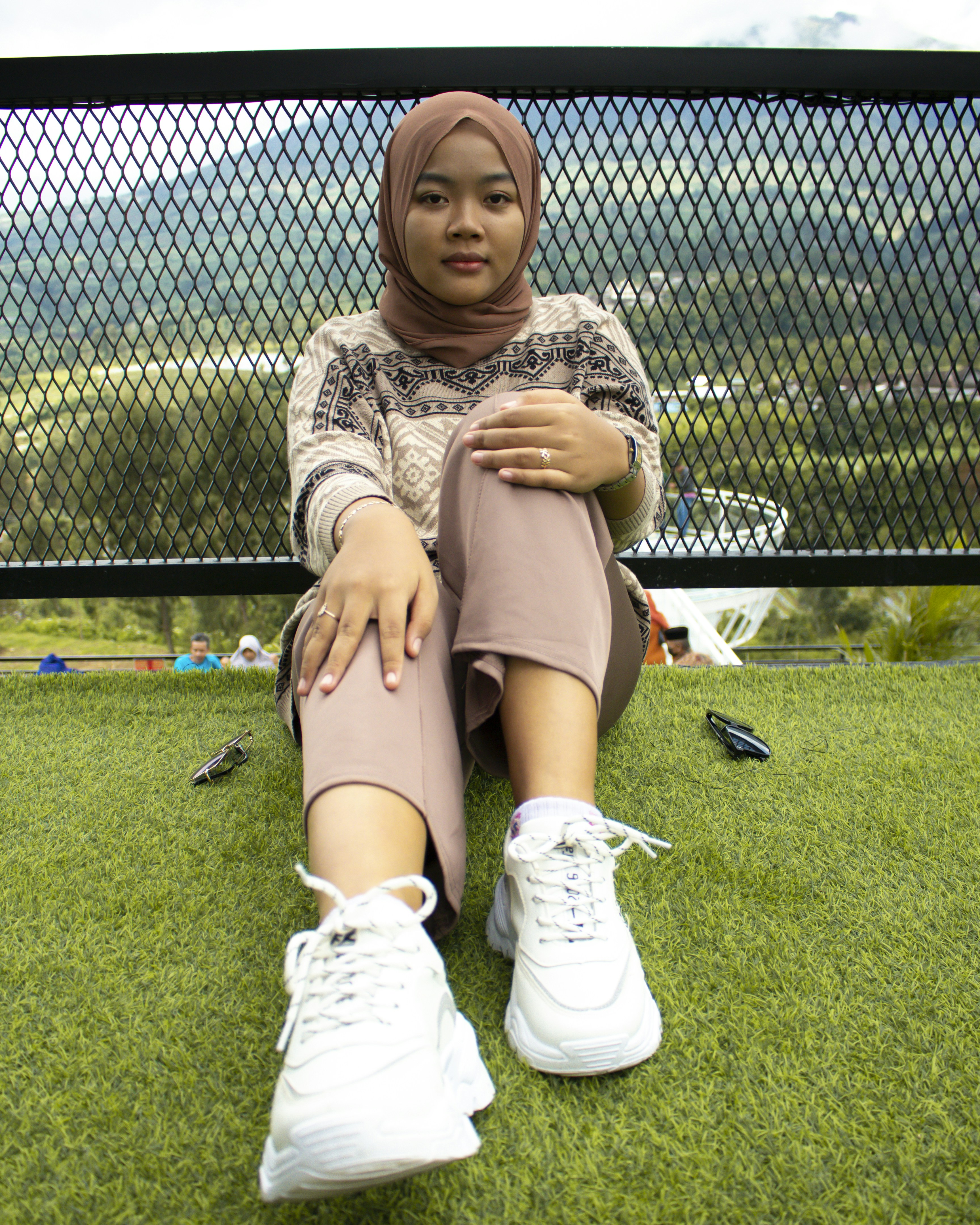 a woman sitting on grass