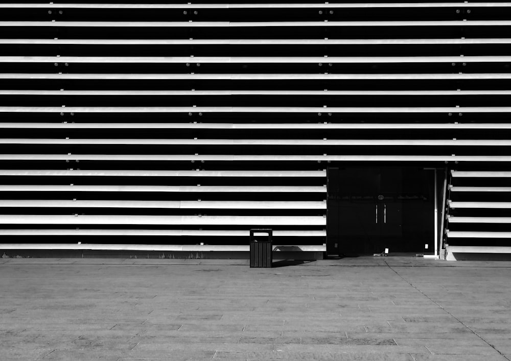 a black door in front of a white wall