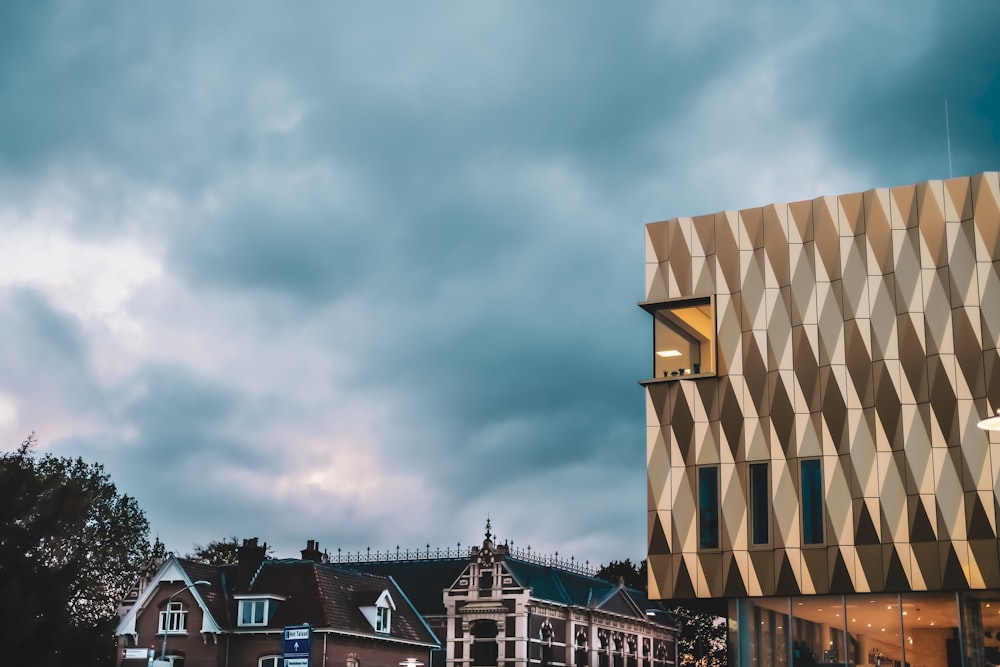 a group of buildings with a cloudy sky above