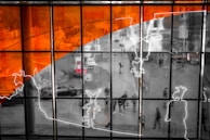 Vinyl one-way window film applied on a shopfront showcasing a vibrant cityscape.