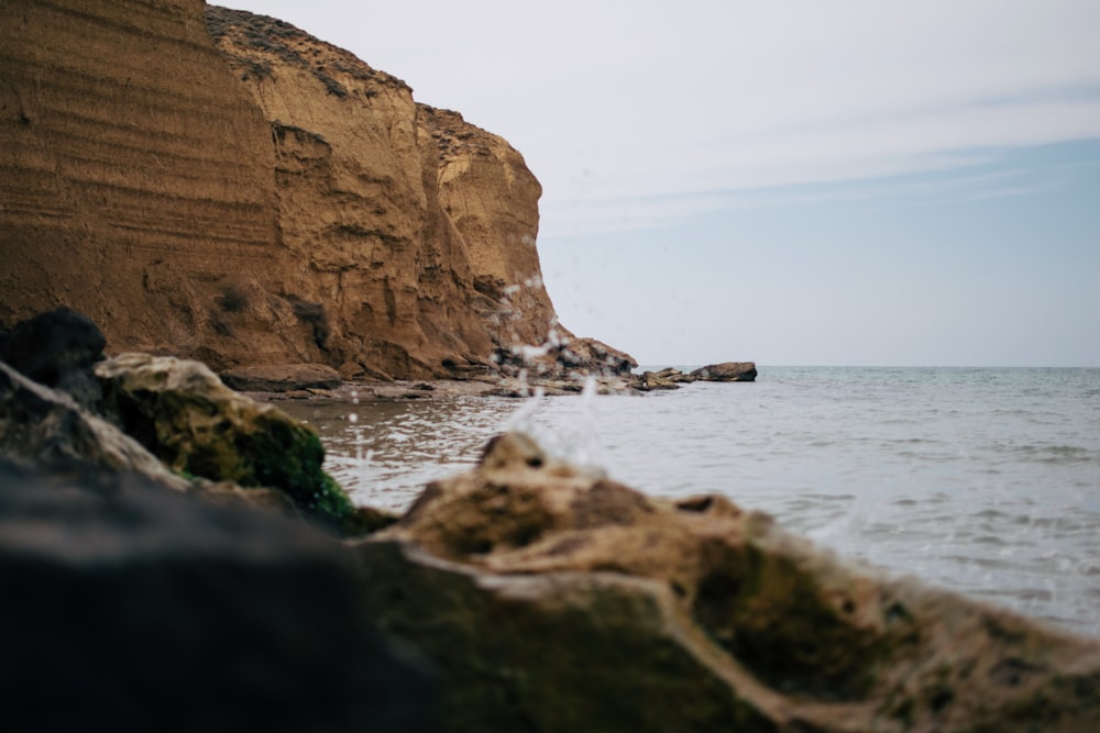 a rocky cliff next to the ocean