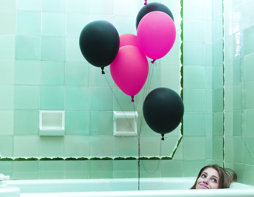 a group of balloons in a bathtub