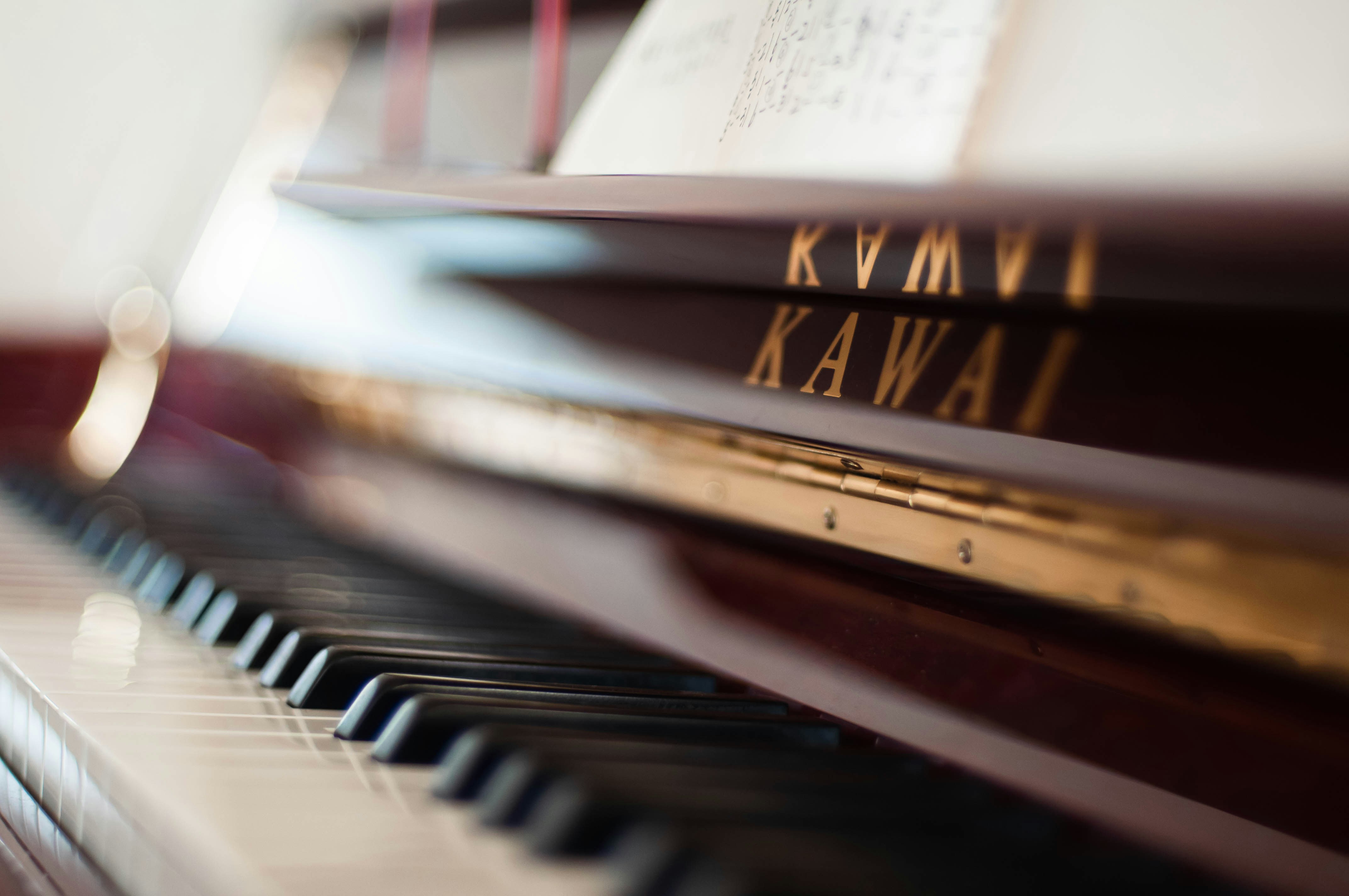a piano with a book and a pen on top