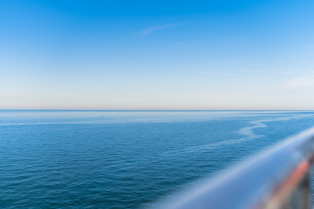 a body of water with a blue sky above it