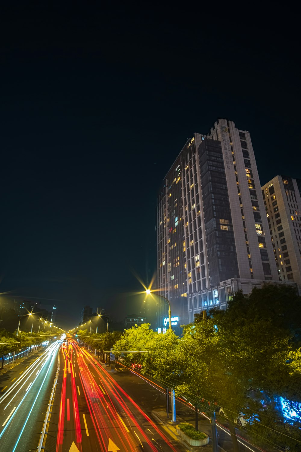 a street with cars on it and buildings in the back