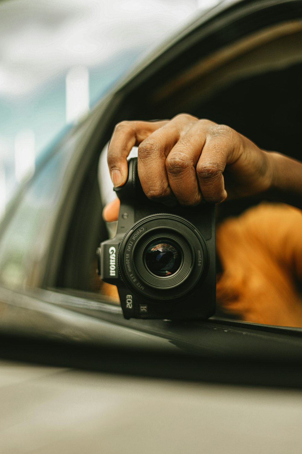 a hand holding a camera