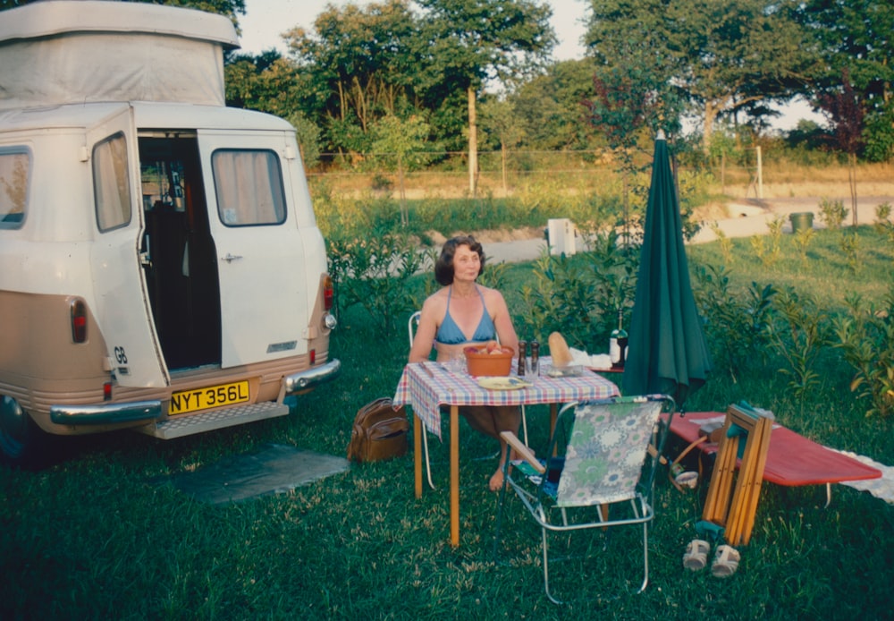 a person sitting at a table outside