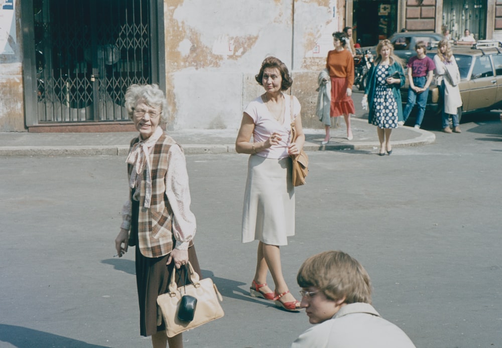 a group of people walking on a street