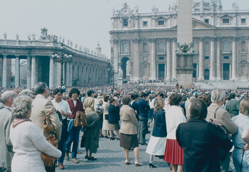 a group of people walking in front of a crowd