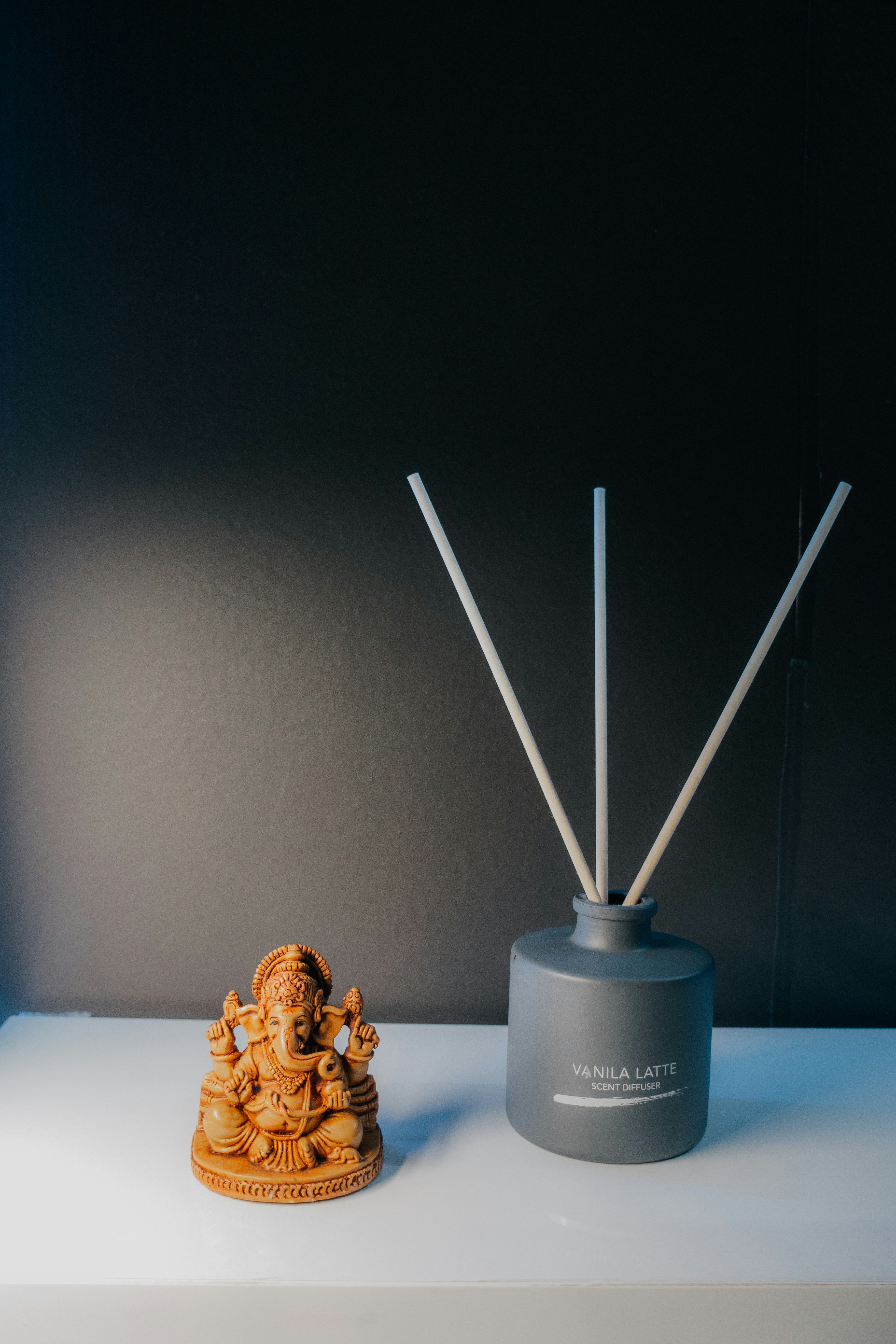 Soft neutral-toned items evoking a creamy vanilla essential oil note