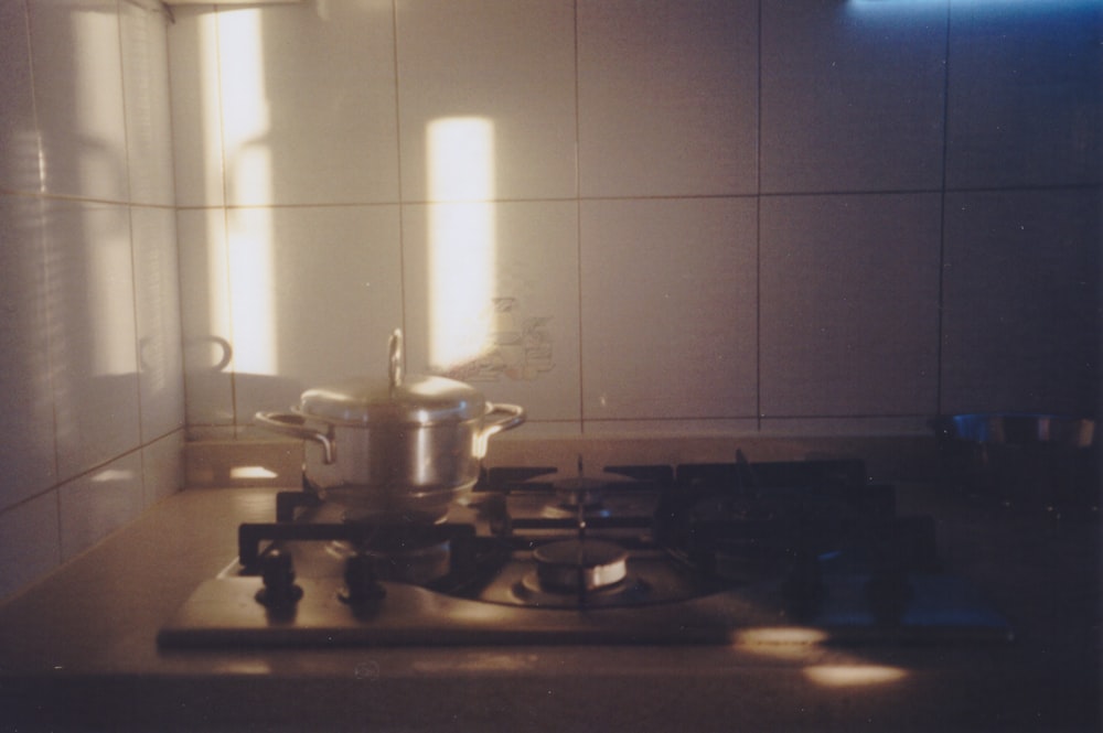 a kitchen with a stove and a pot on a stove