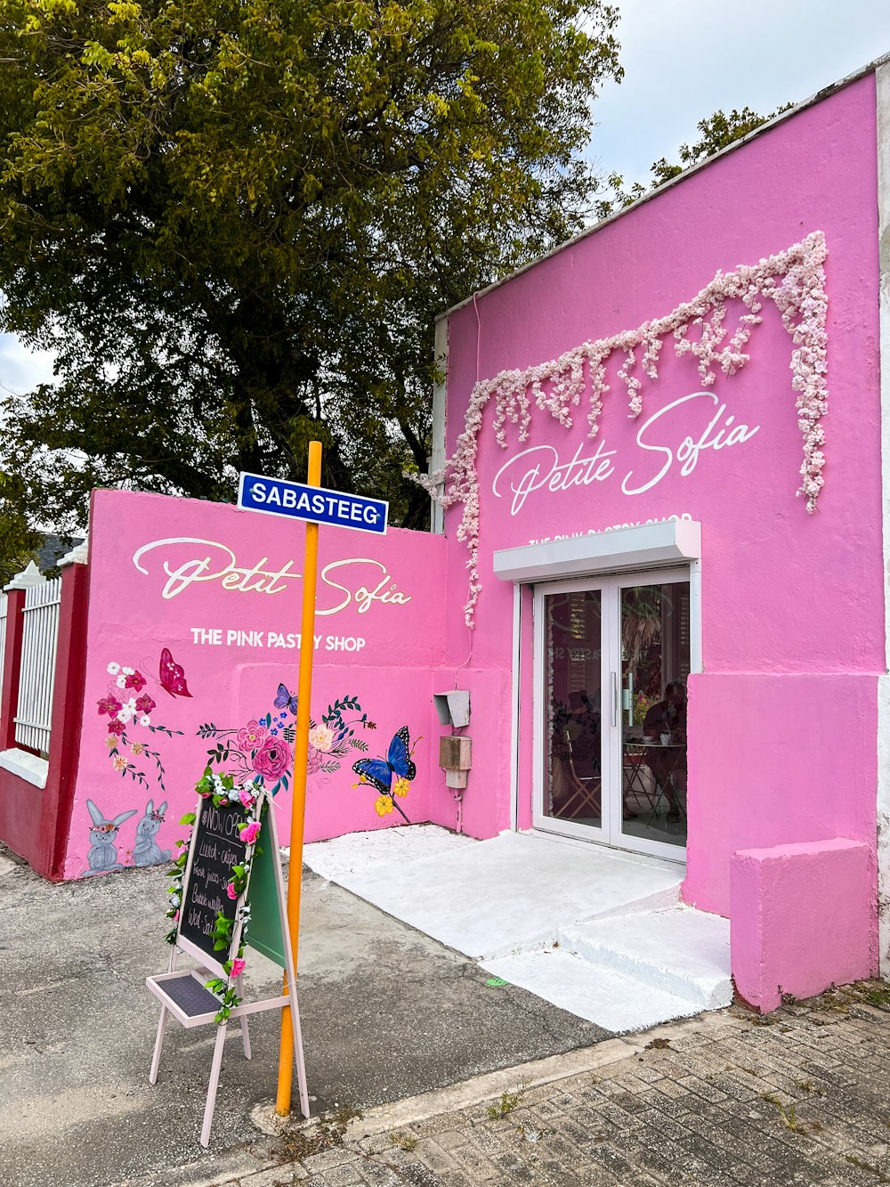 a pink building with a sign