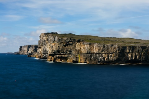 a cliff with a body of water below