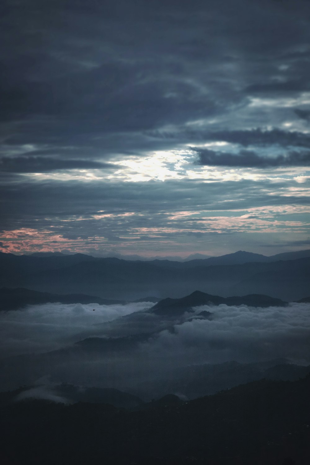 a view of the clouds and mountains