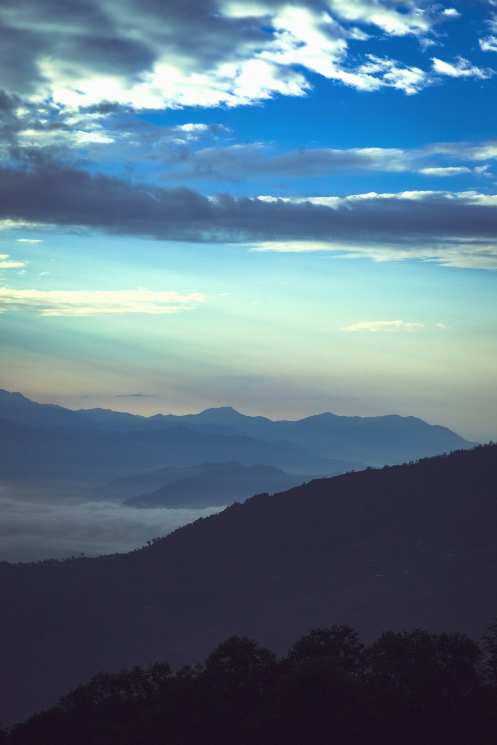 a landscape with mountains and clouds