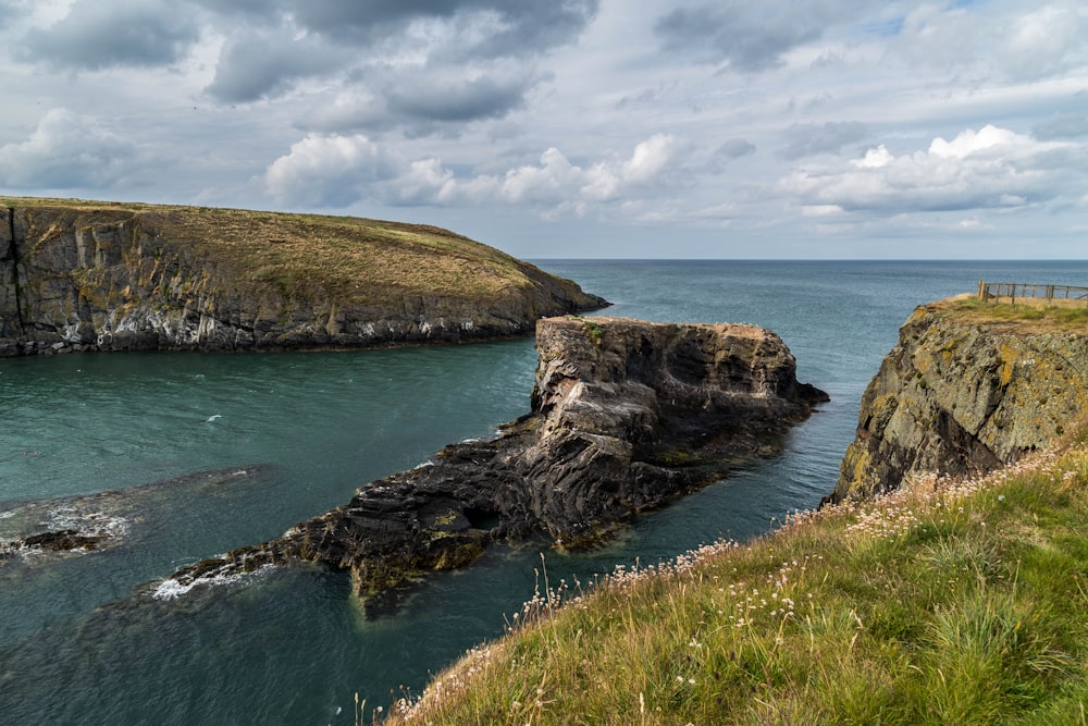 a rocky cliff next to the ocean