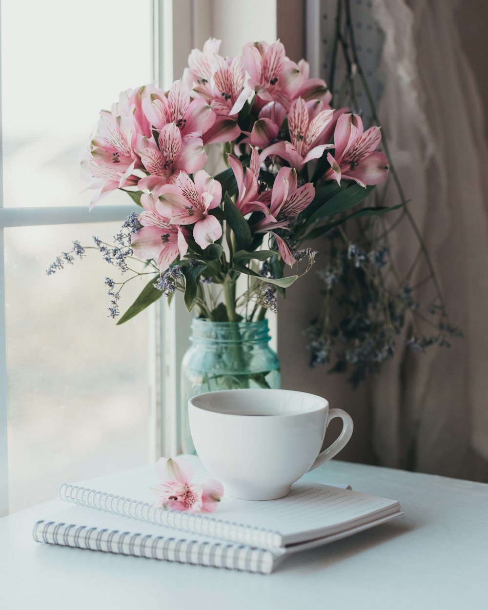 a vase with pink flowers