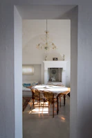 An elegant dining area styled with minimalist décor pieces from élégancevive, bathed in warm evening light.