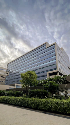 A wide-angle view of a newly constructed government office building in West Bengal under clear skies.