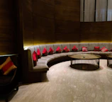 Comfortable seating area in deluxe suite with elegant decor and soft cushions.