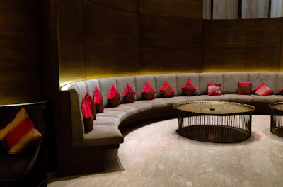 Comfortable seating area in deluxe suite with elegant decor and soft cushions.
