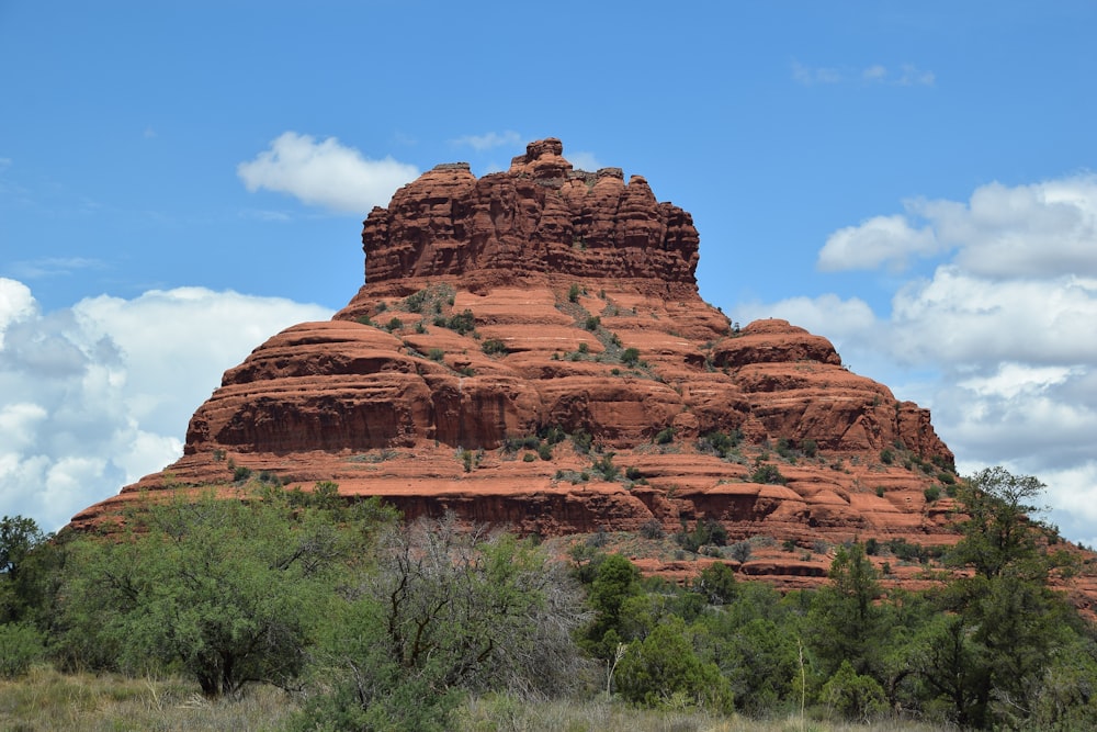a large red rock formation with Bell Rock in the background