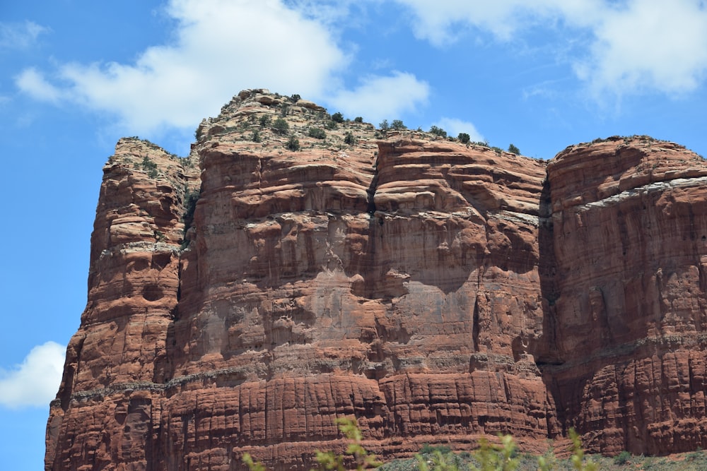 a rocky cliff with a blue sky