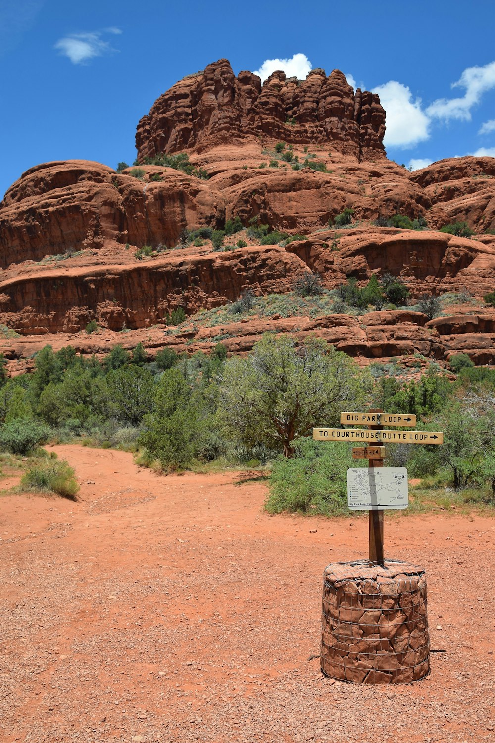 a sign in front of a rock formation