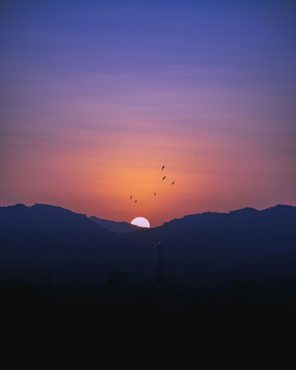 a sunset over a mountain range