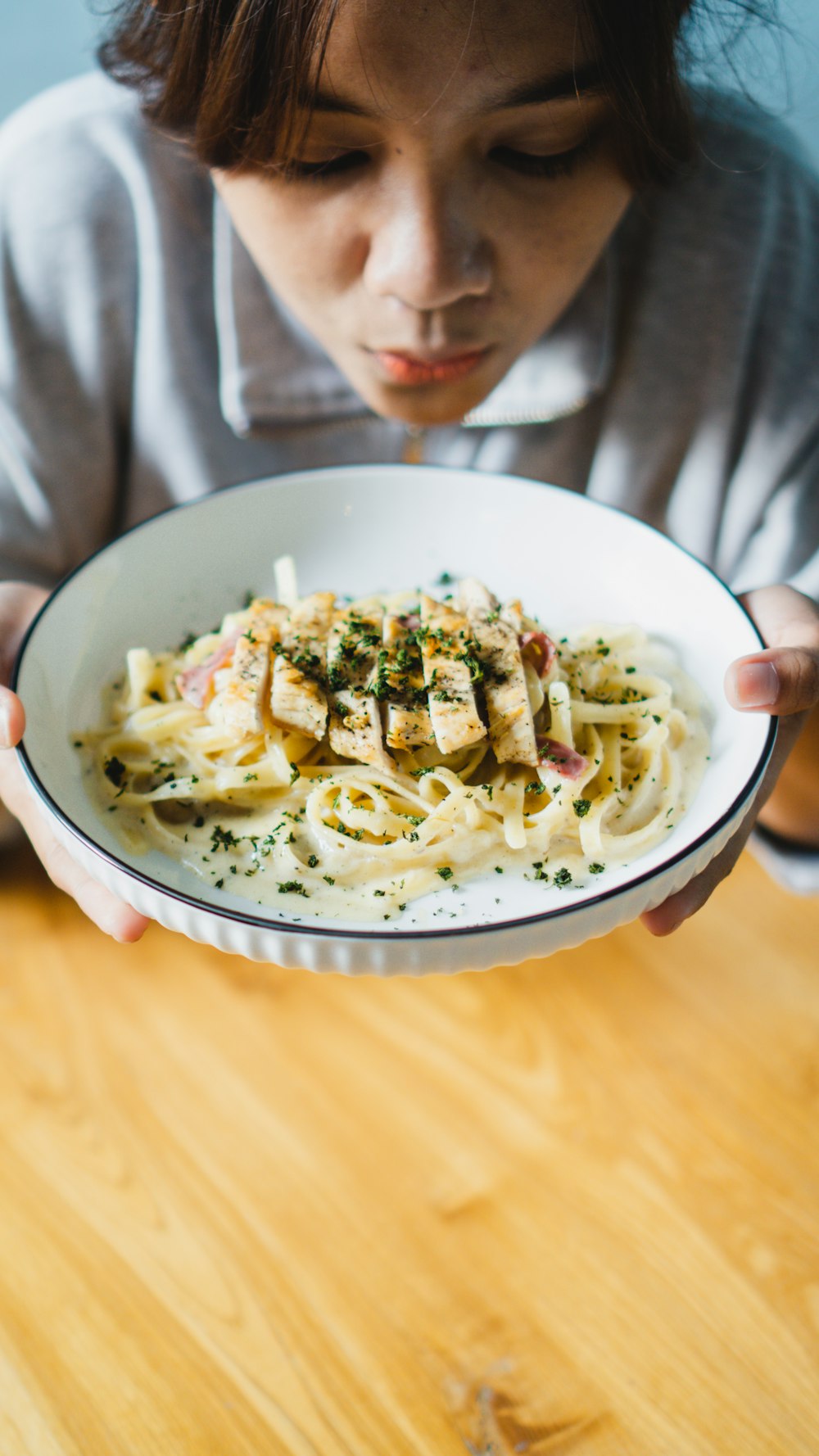 a woman holding a bowl of food