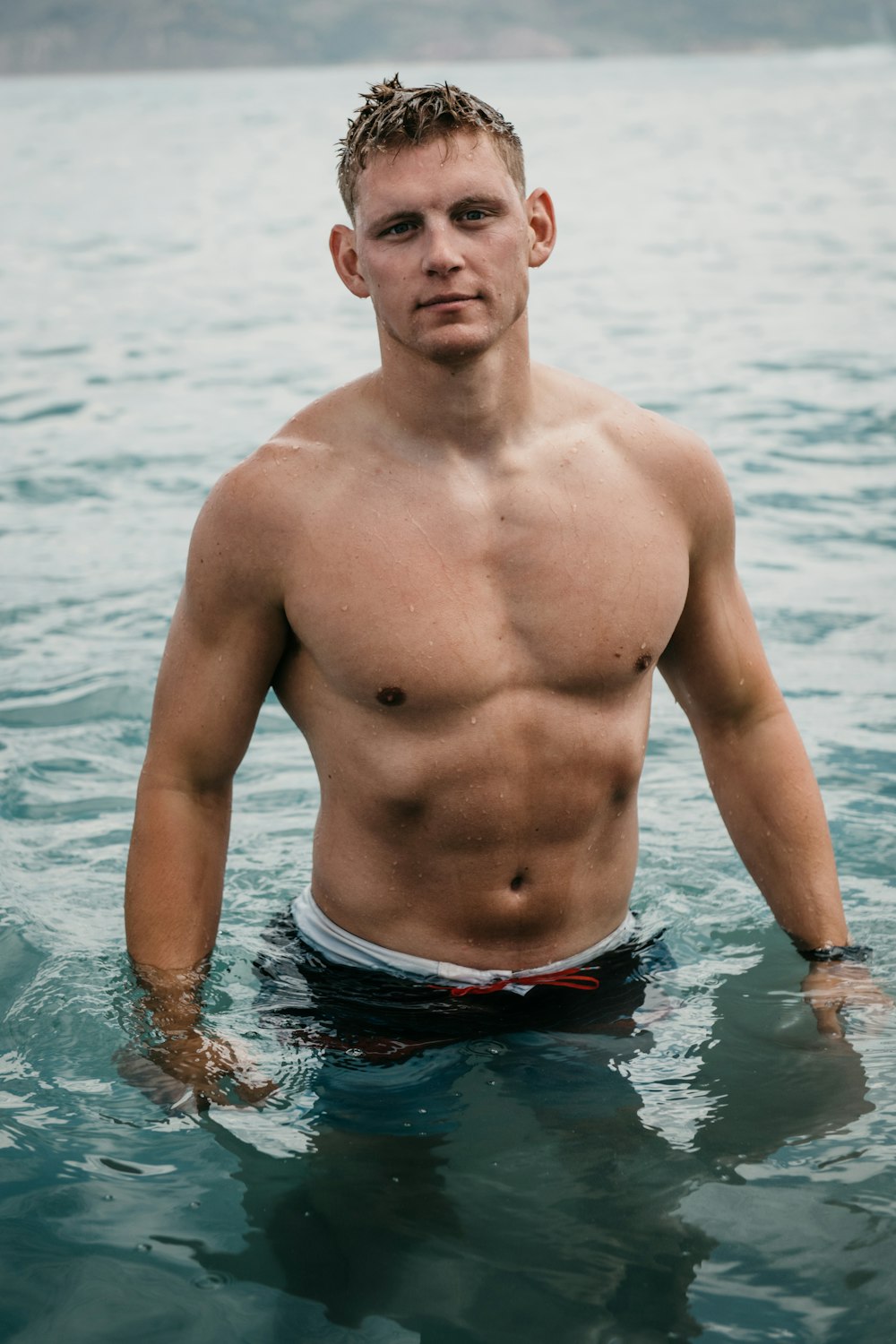 a man in a swimsuit in the water