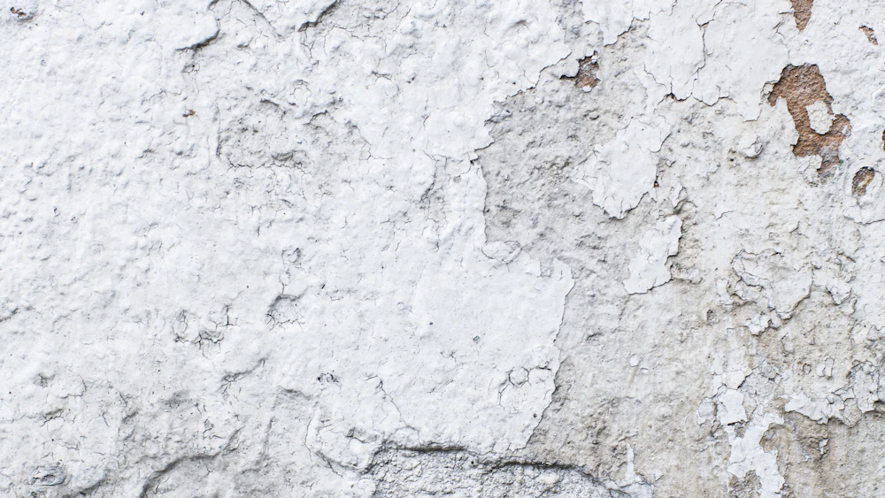 Close-up of cracked white plaster ready for repair