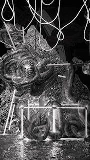 A tangled maze of neon-lit wires and shadows symbolizing the system’s control, with a solitary figure struggling to break free.