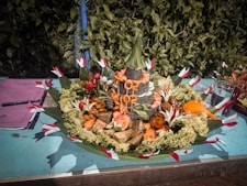 Colorful handmade local foods artfully displayed on a traditional serving platter.