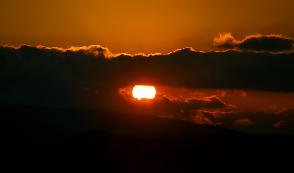 a sunset over a mountain