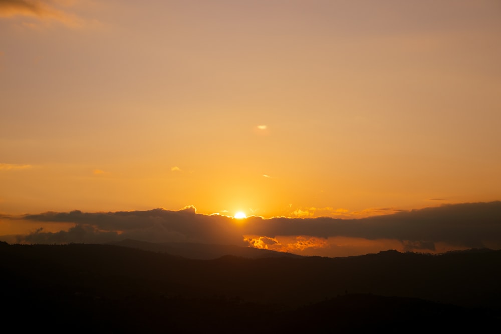 a sunset over a mountain range