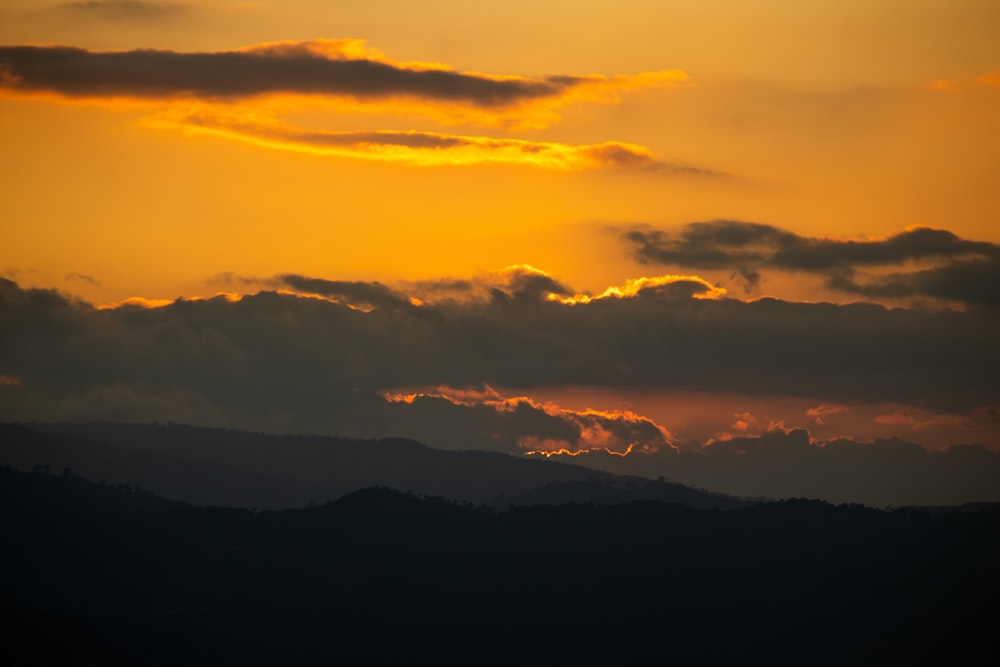 a sunset over a mountain range