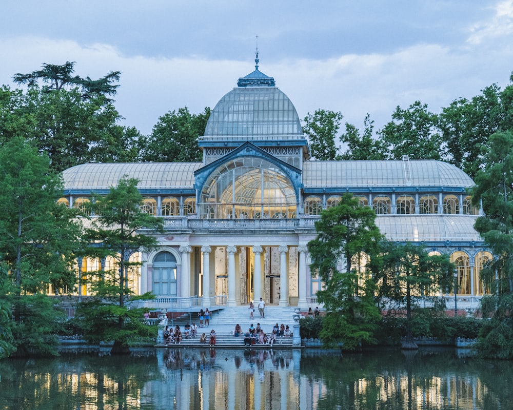 a building with a dome roof and a body of water in front