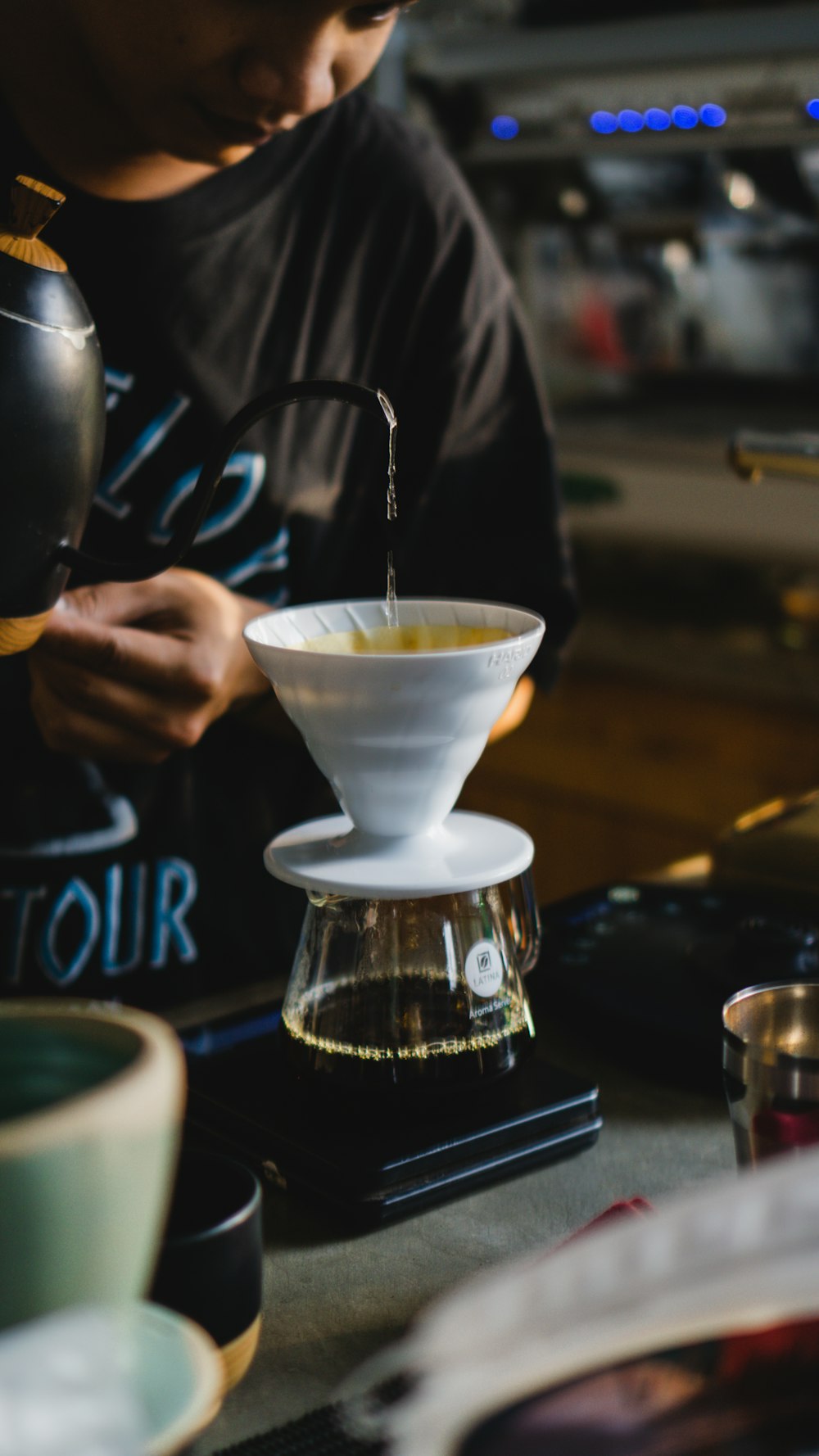 a person pouring a drink into a glass