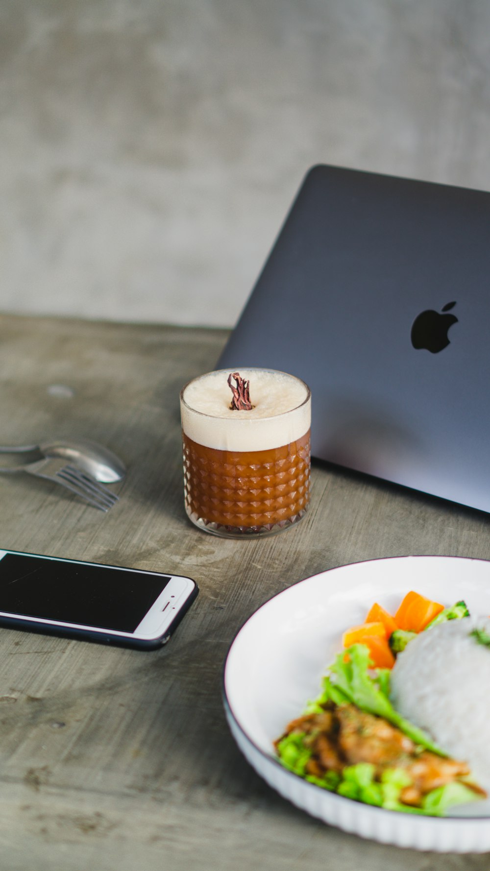 a plate of food and a cell phone on a table