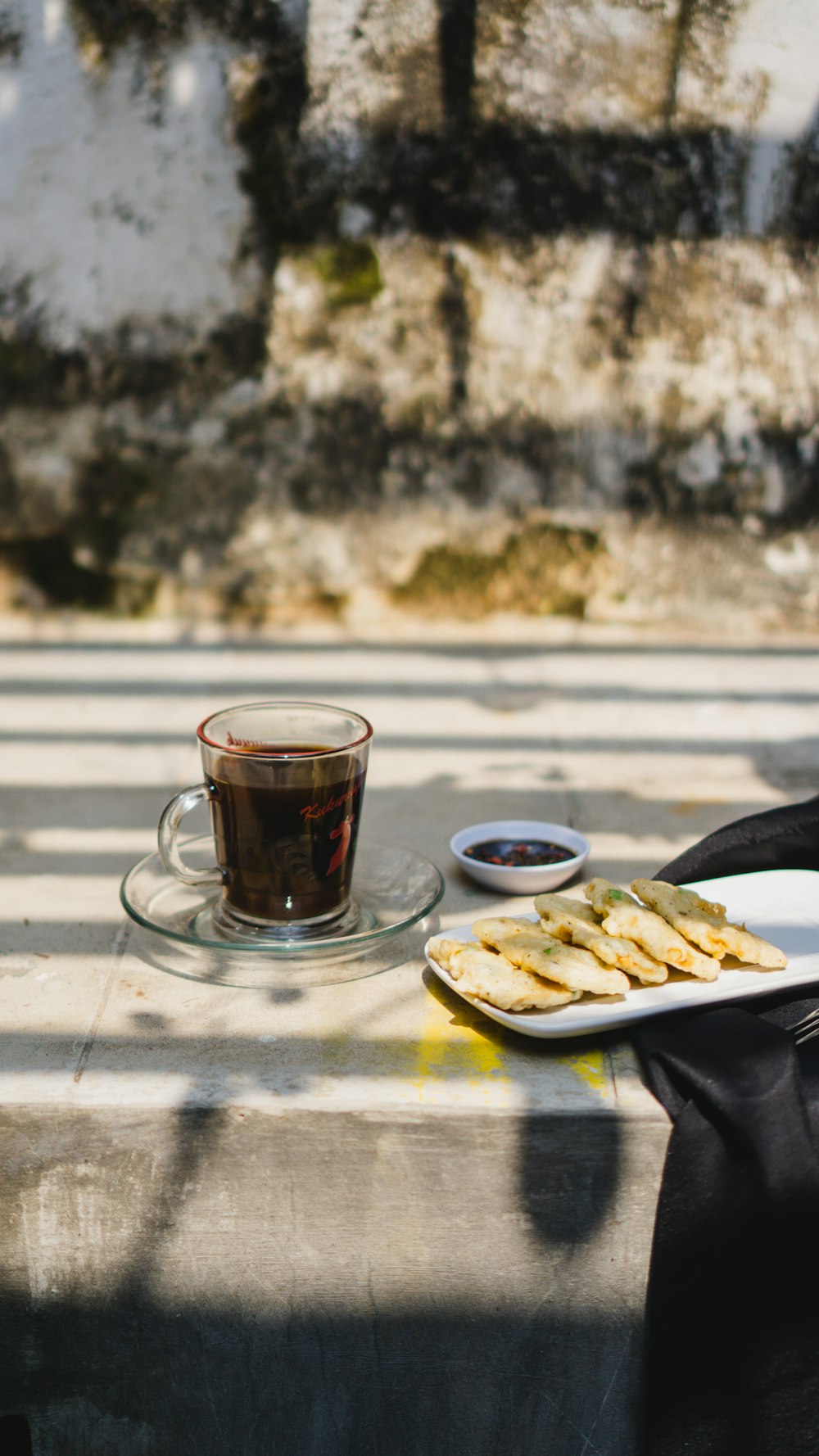 a plate of food and a cup of coffee on a table