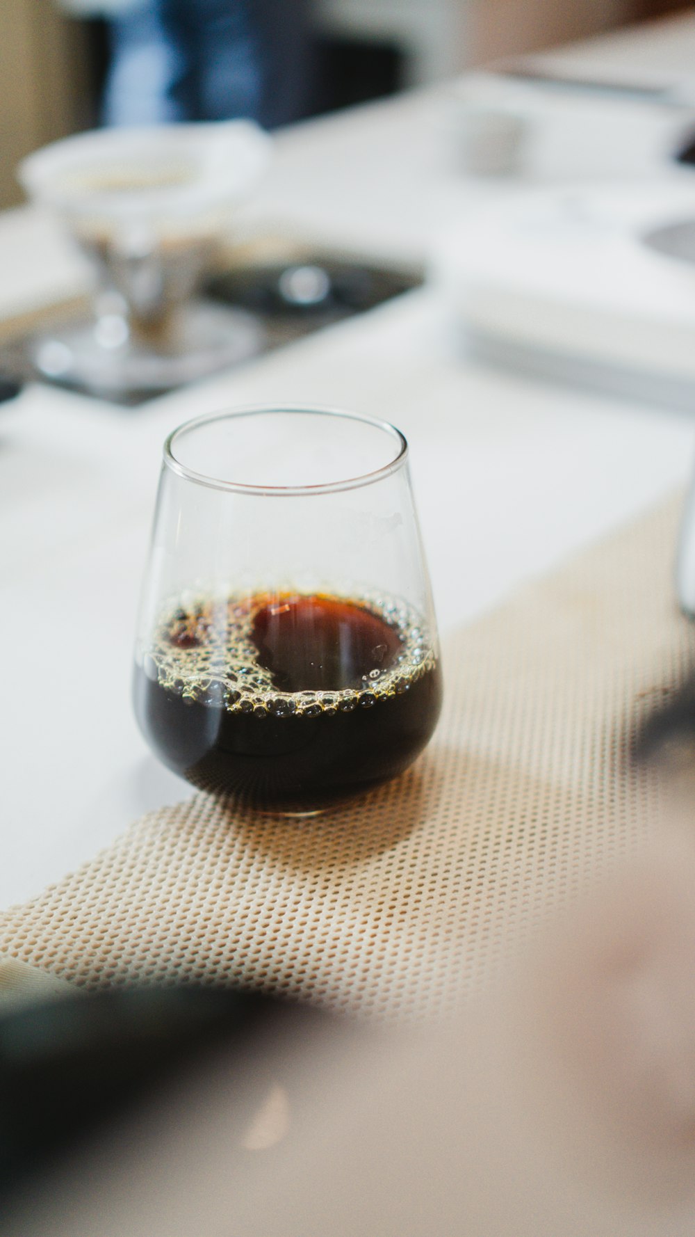 a glass of liquid on a table