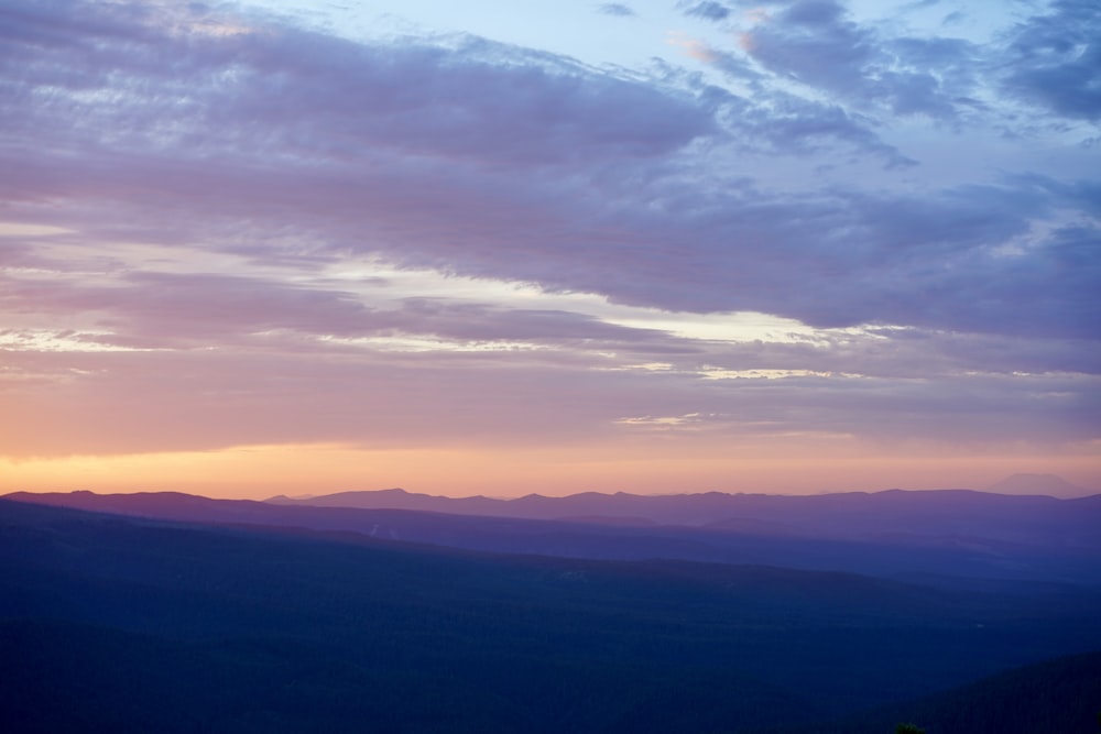 a landscape with hills and clouds