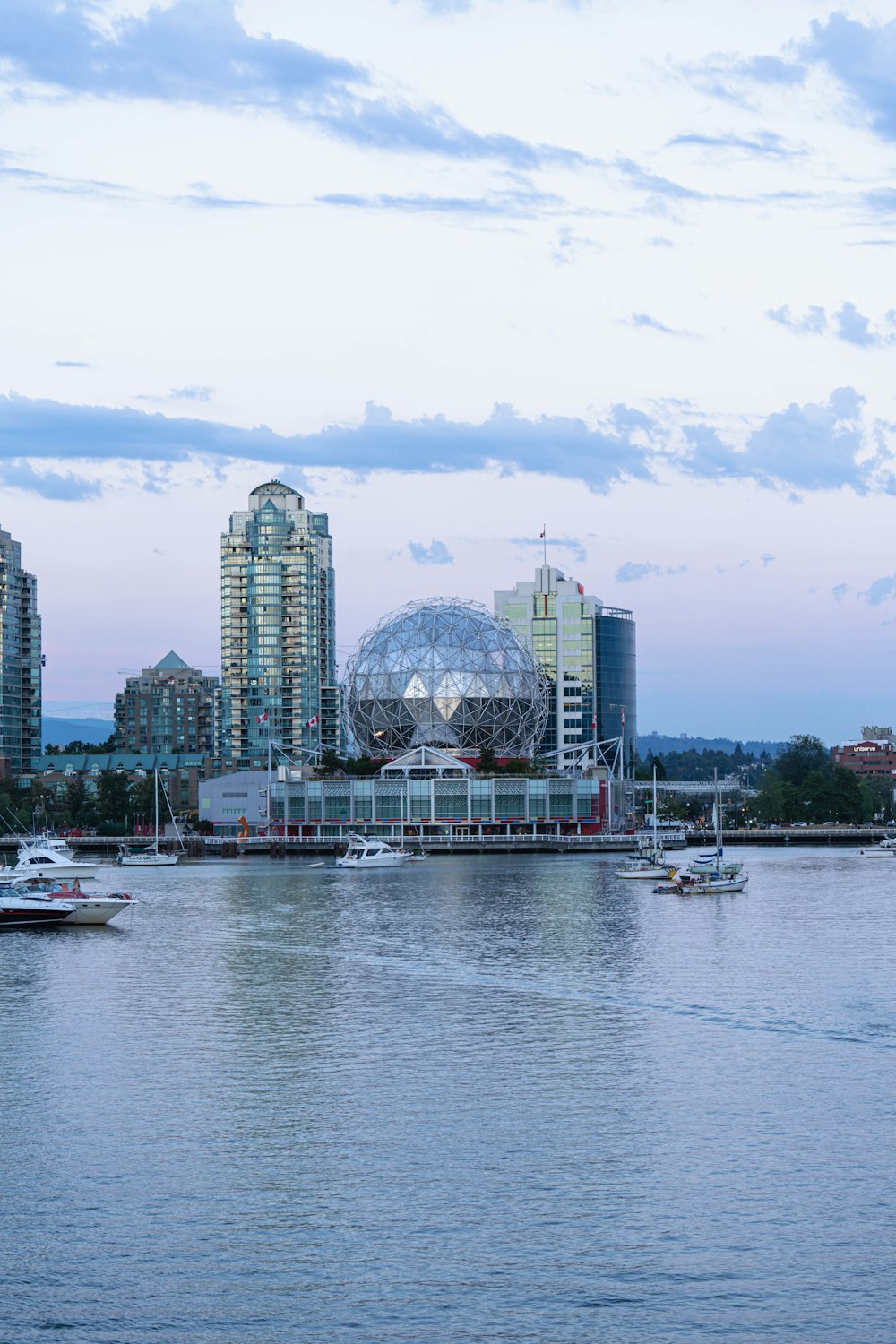 a body of water with boats and buildings in the background