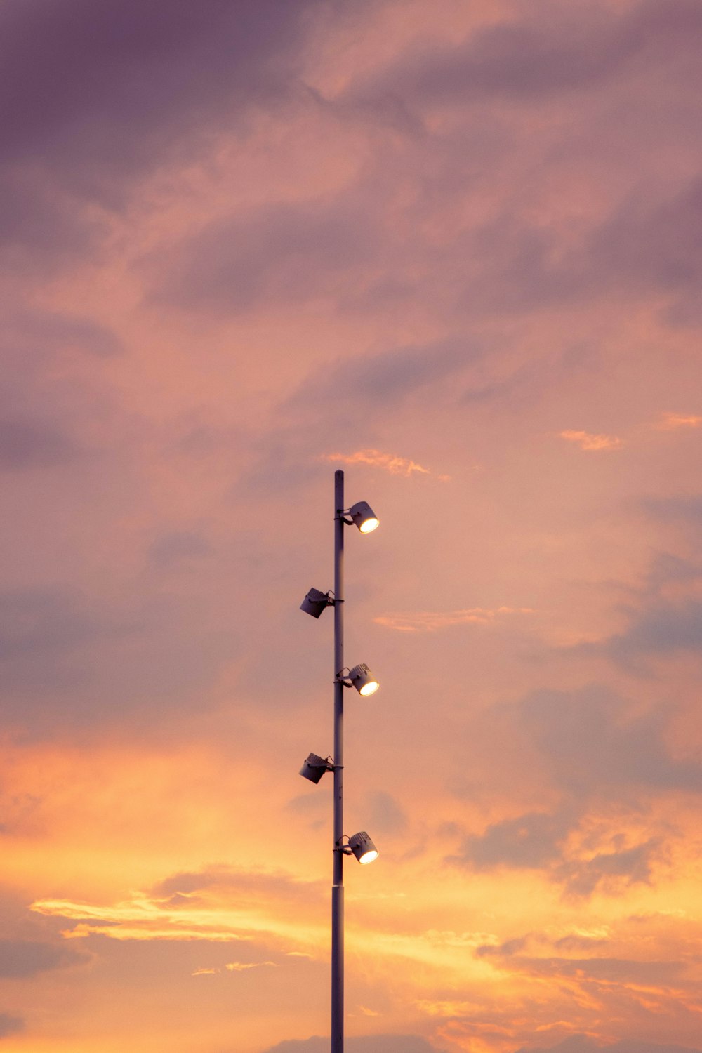 a street light with a cloudy sky